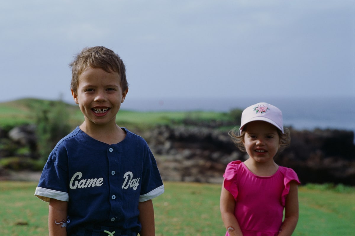 Baker and Romee stand together with the coastal golf course behind them.